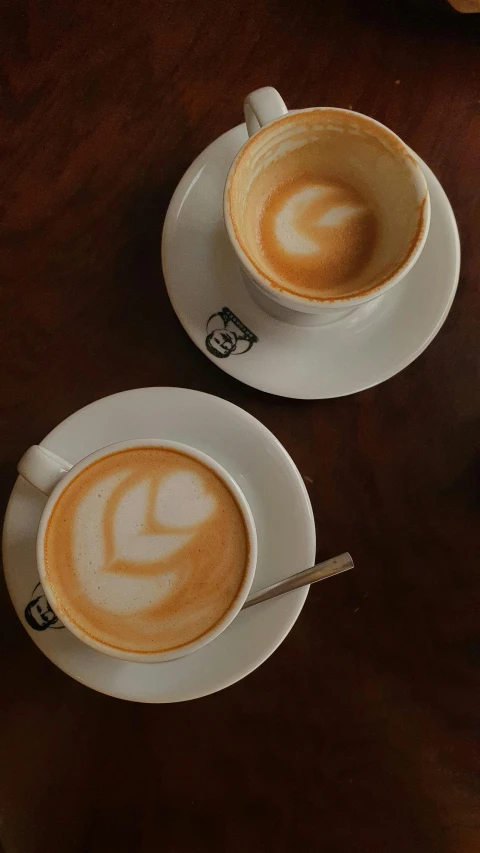 two coffee cups with different designs on them