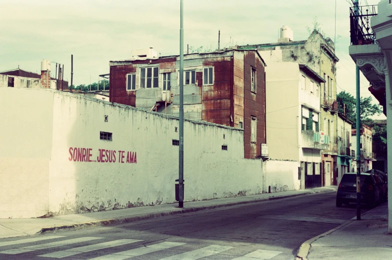 old commercial building next to a street with people