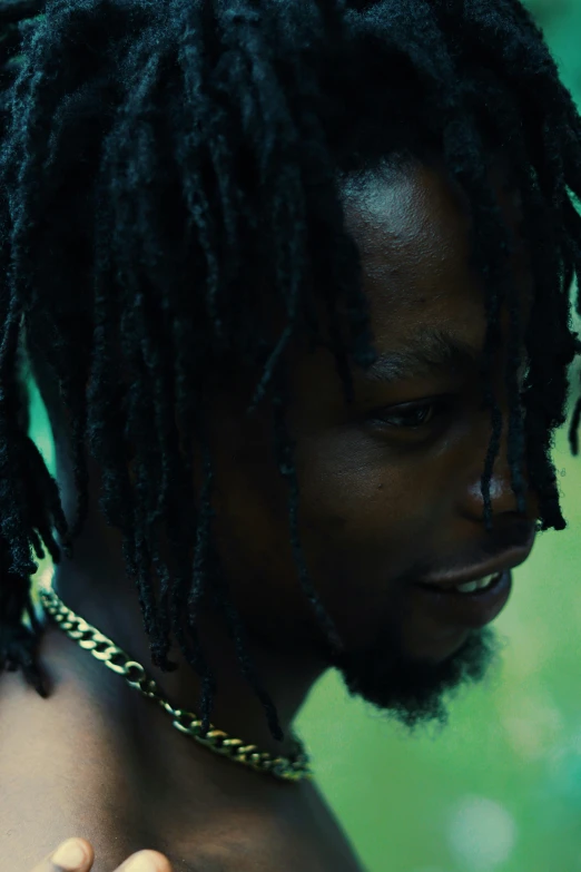 an african american man wearing ids and a necklace