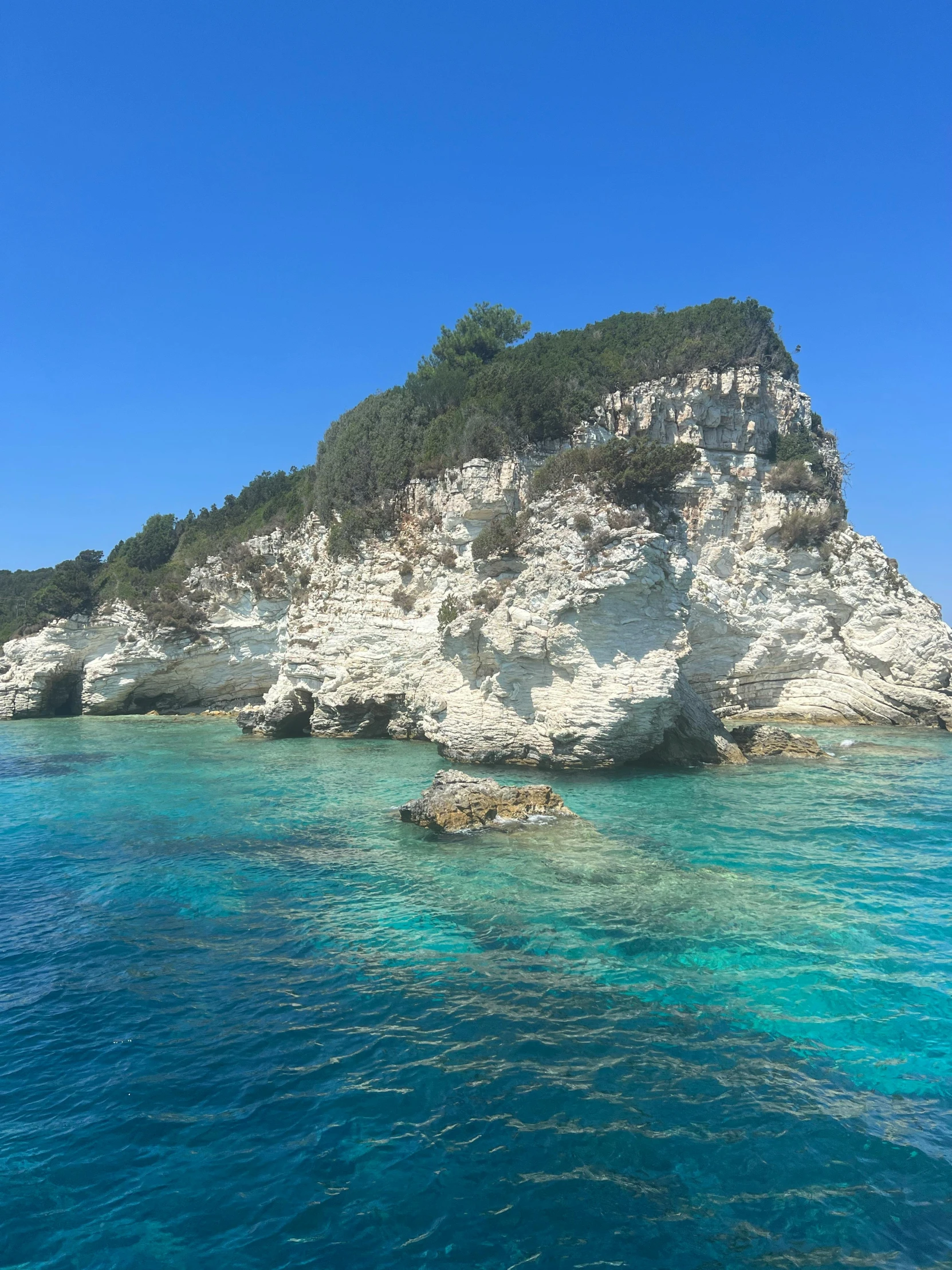 blue water in front of an island on a clear day