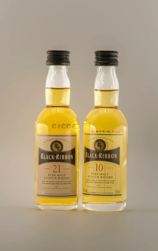 two bottles of whisky sitting next to each other