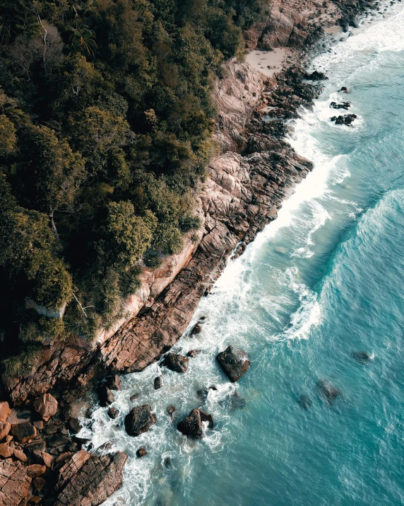 a small beach surrounded by water and hills