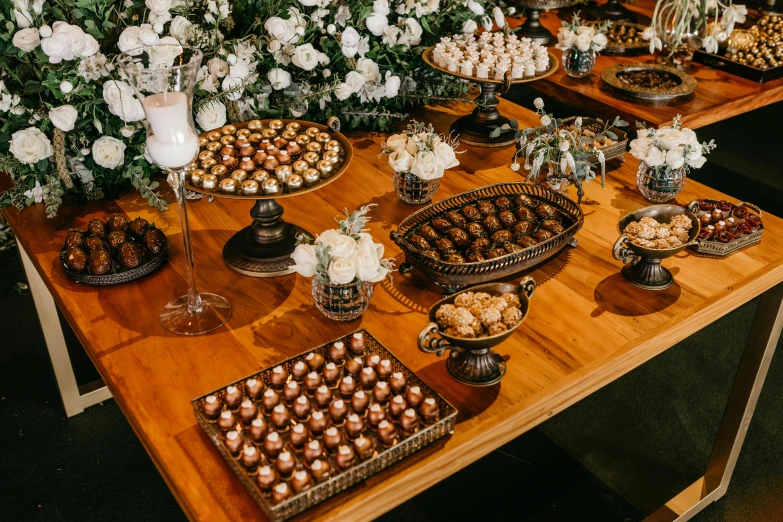 an arrangement of desserts are served on a table