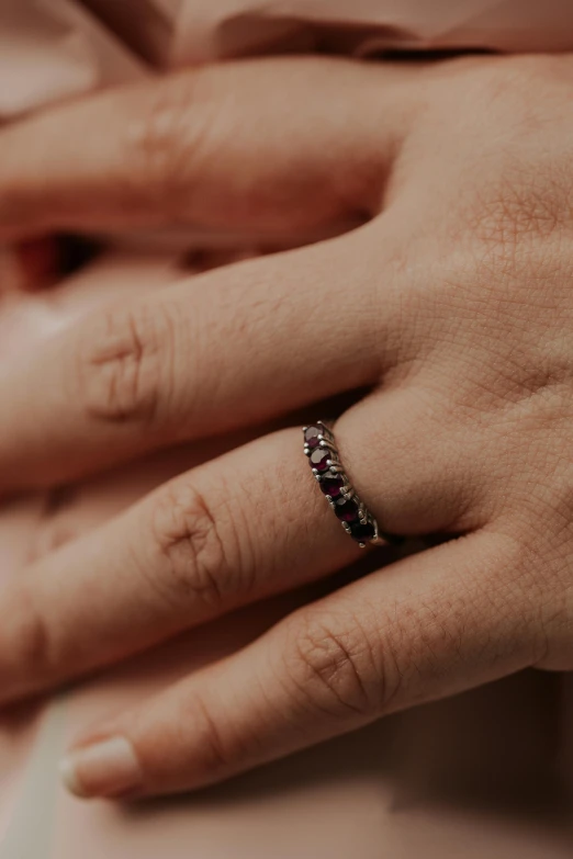 close up view of a diamond ring being held by two hands