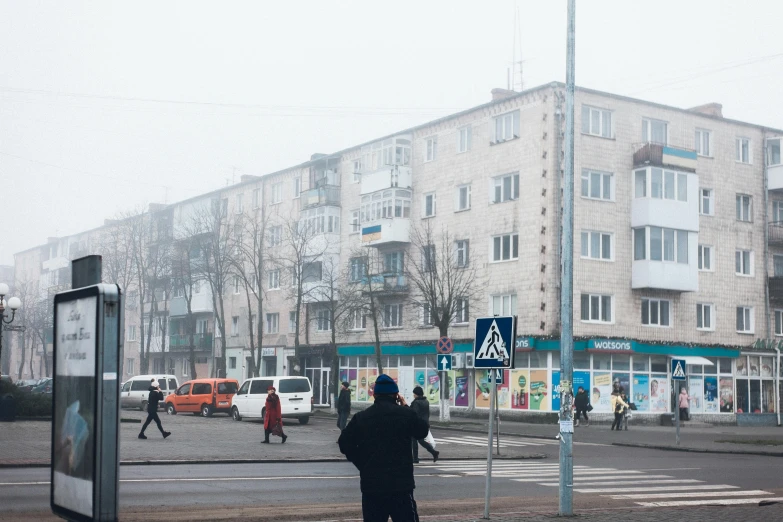 a person standing on the street with his hands in his pockets