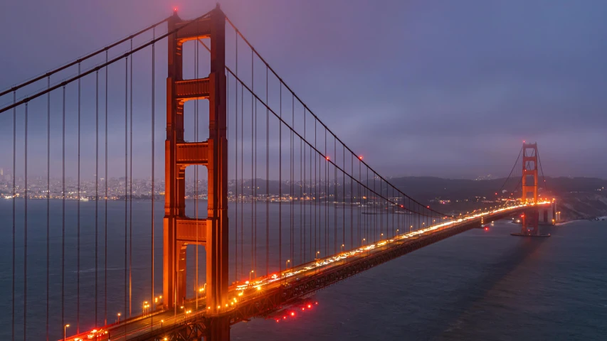 a bridge lit up with lights and water