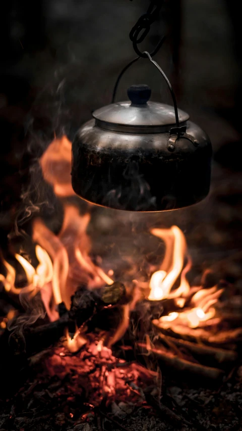 a tea kettle is being used over a fire