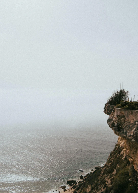 some people looking at the water in the distance