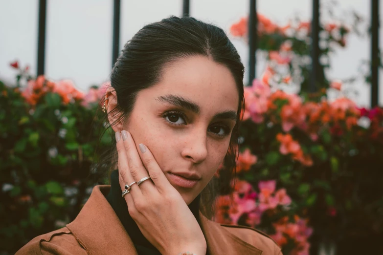 a girl with an interesting ring looks to the camera