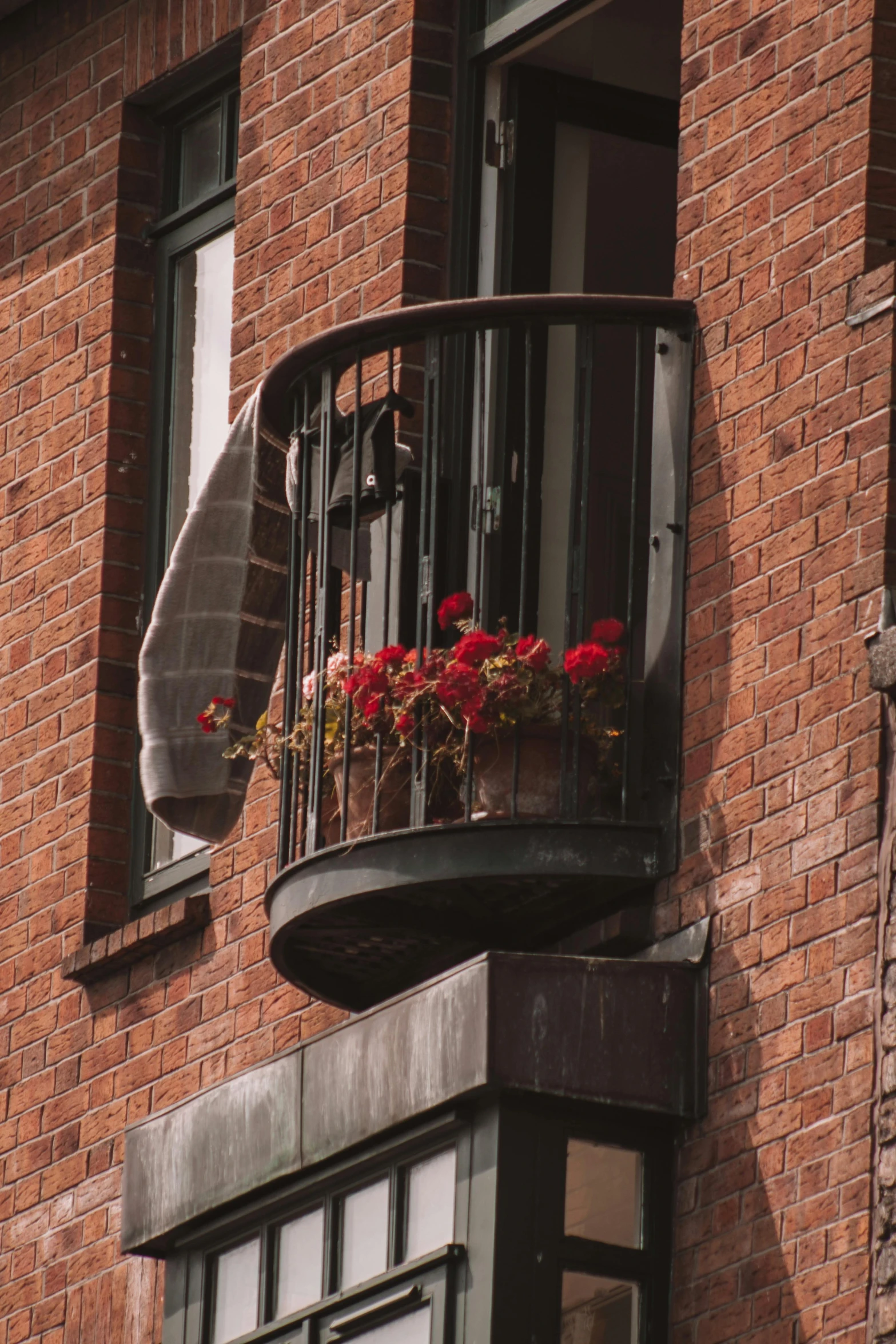 an outdoor balcony with flower box and potted plant on it