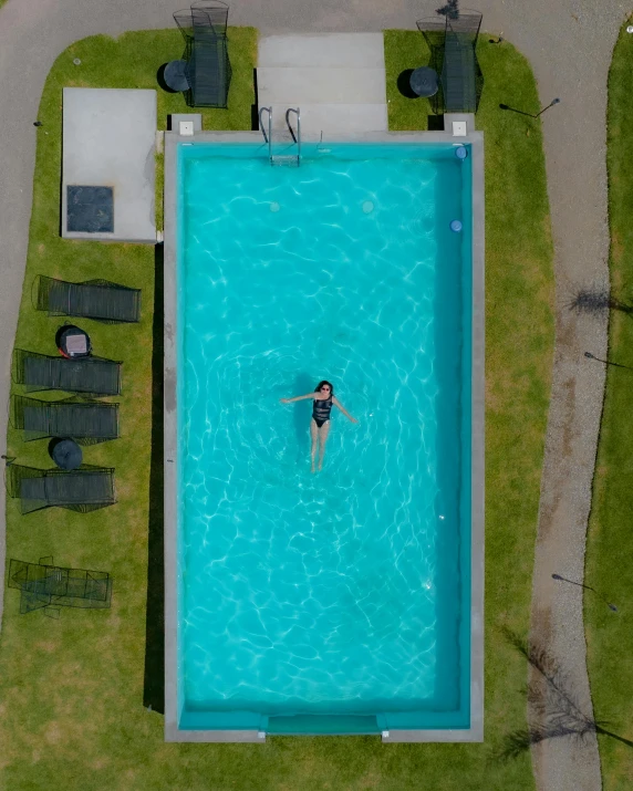 a man in black swimsuit standing in a pool