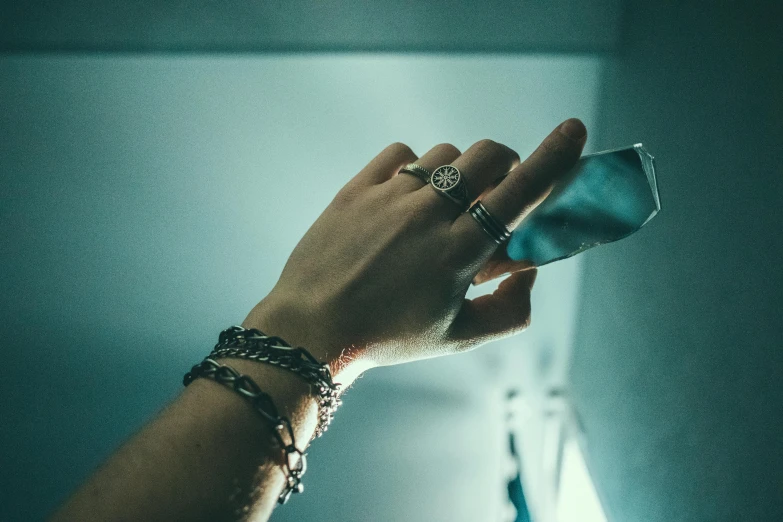 the hand of a woman holding a cellphone to her ear