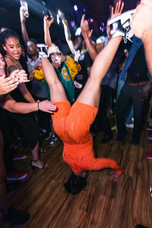 a person doing a handstand on the dance floor