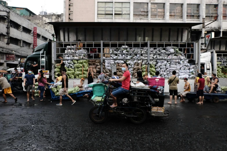 many people stand in the street near a building