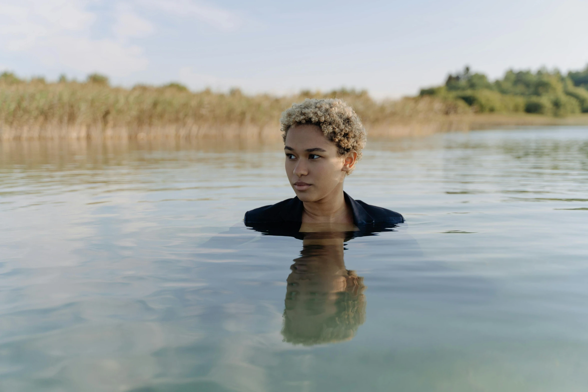 young woman swimming in the water outside