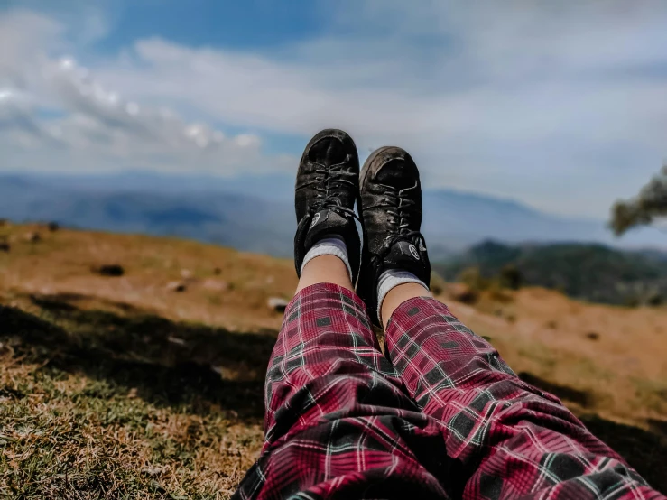 view from the ground of someone wearing black shoes