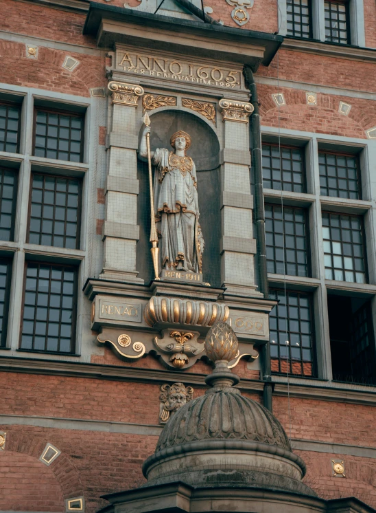 an old brick building has a decorative balcony and clock