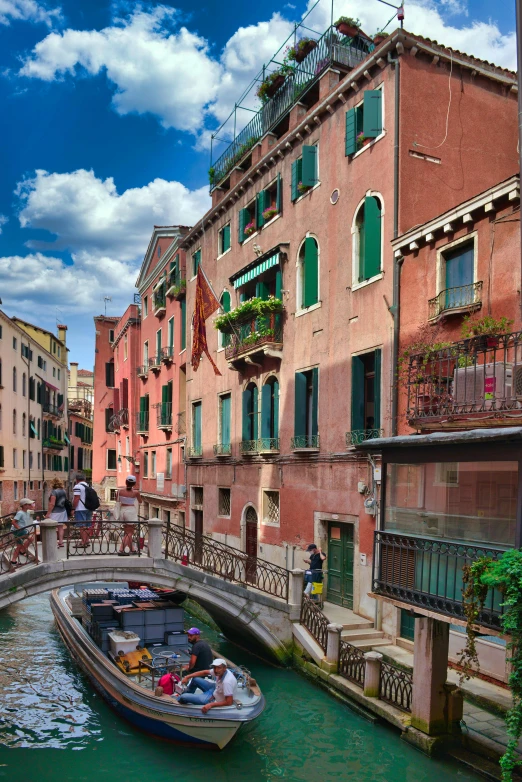 a boat is floating in a canal between houses