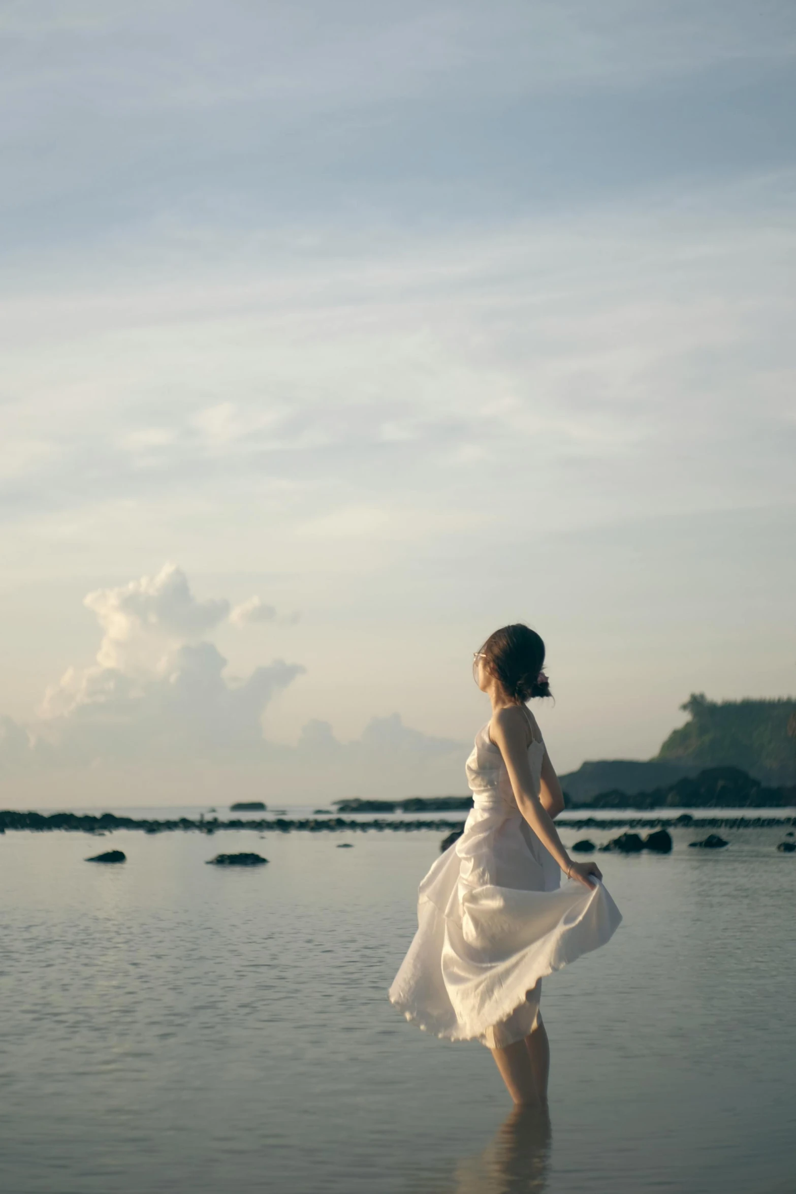 a woman is wearing a dress in a lake