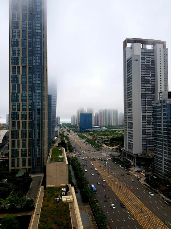 buildings with tall towers and many cars on roadway