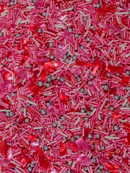 many pink pieces of sprinkles and other things