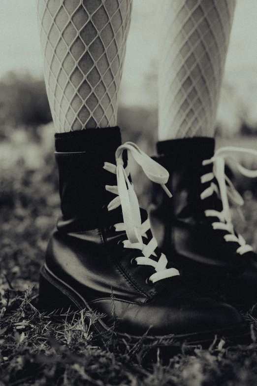 the legs and boots of an adult wearing lace socks