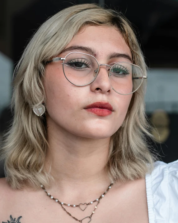 a woman wearing glasses and a necklace