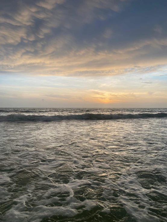 ocean waves with sun reflecting in the water