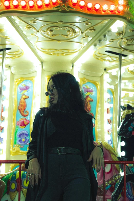 a woman standing at a merry go round