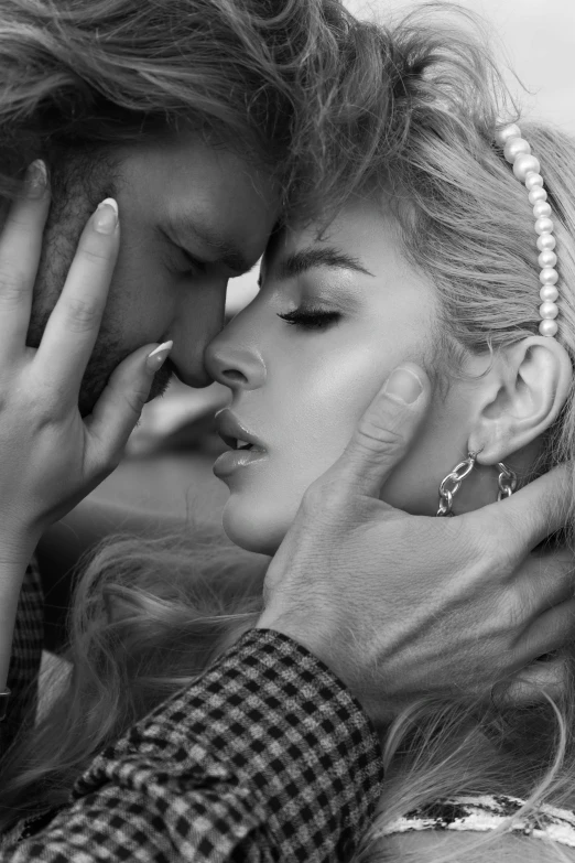 a beautiful woman kissing a man in a black and white po