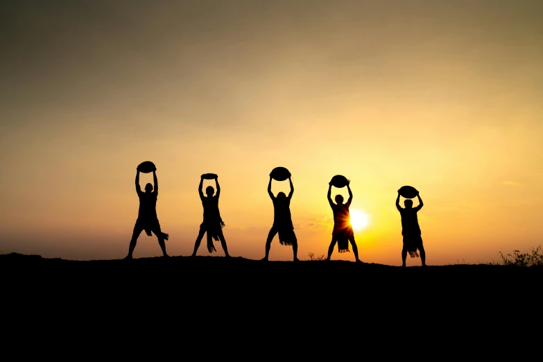 the silhouettes of people with their arms in the air