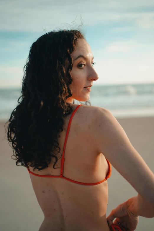 a young woman in a red bikini on the beach