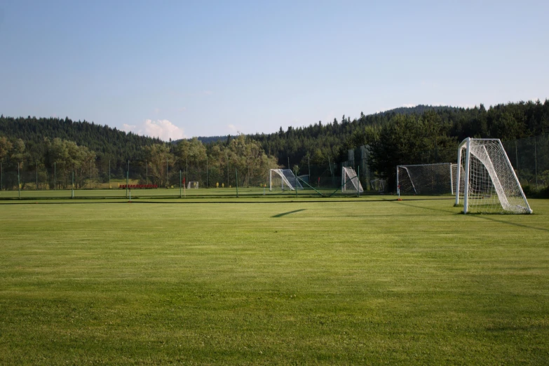 a soccer field with a goal and other sports equipment