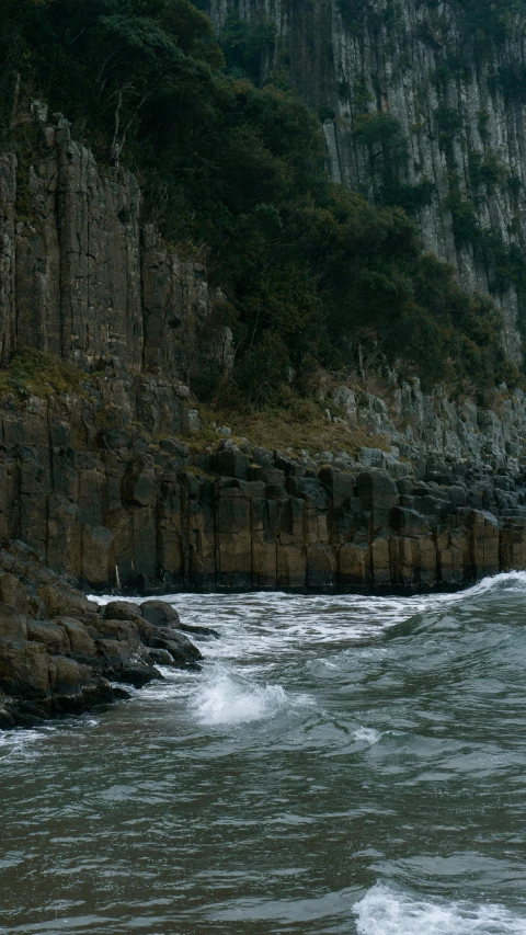 the shore line on a rock covered shore