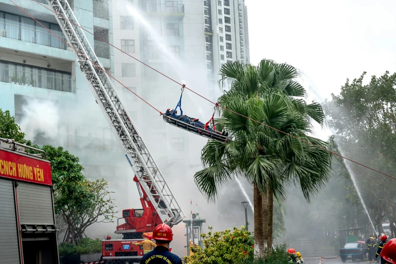 a fire engine spraying water into the air next to trees