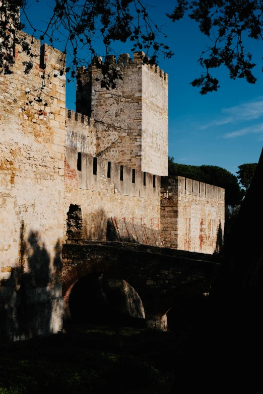 an old building with a bridge in front of it