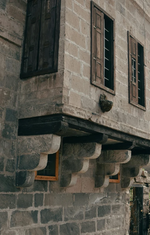 an old house with wood shutters and wood windows