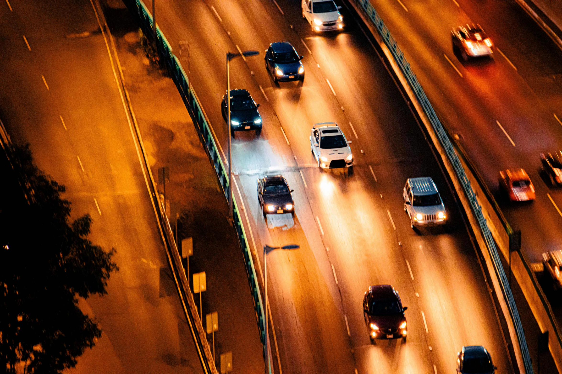 night time traffic on a highway with traffic lights