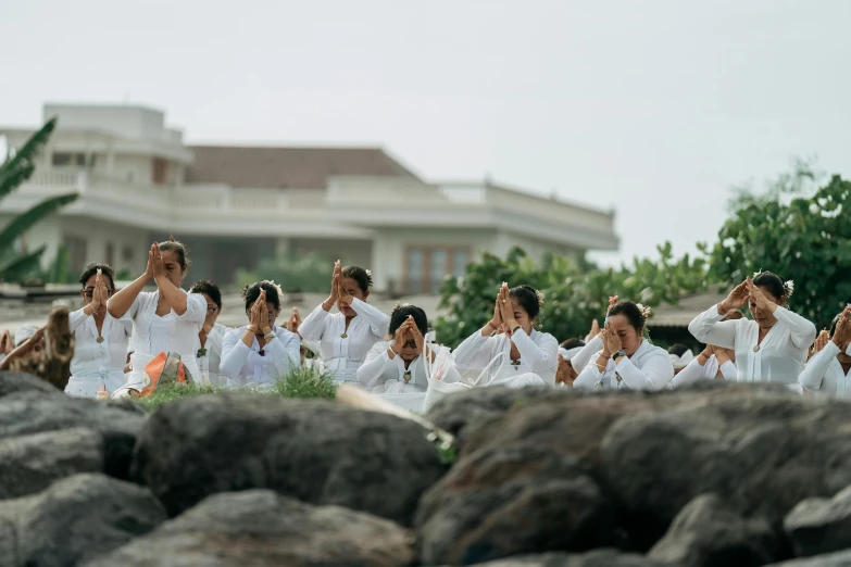 a group of people dressed in white standing around