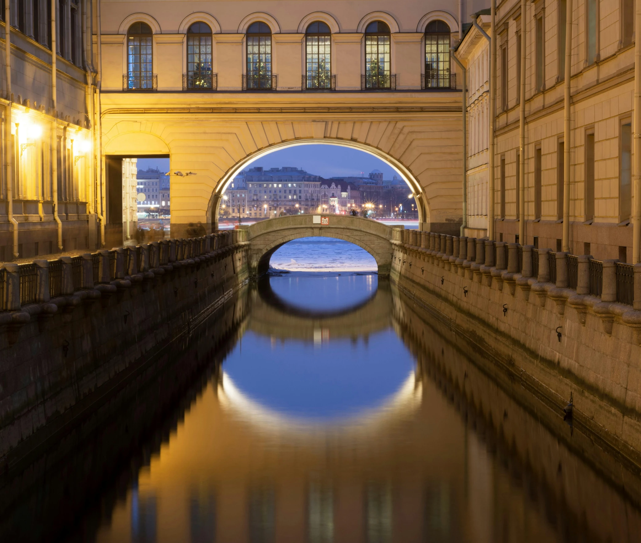 looking up at an arched river under a bridge