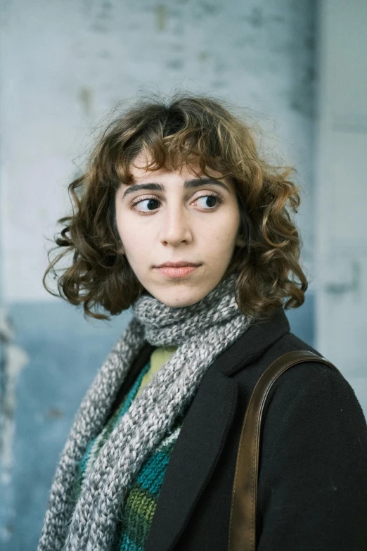 a woman looking up with her handbag on the shoulder