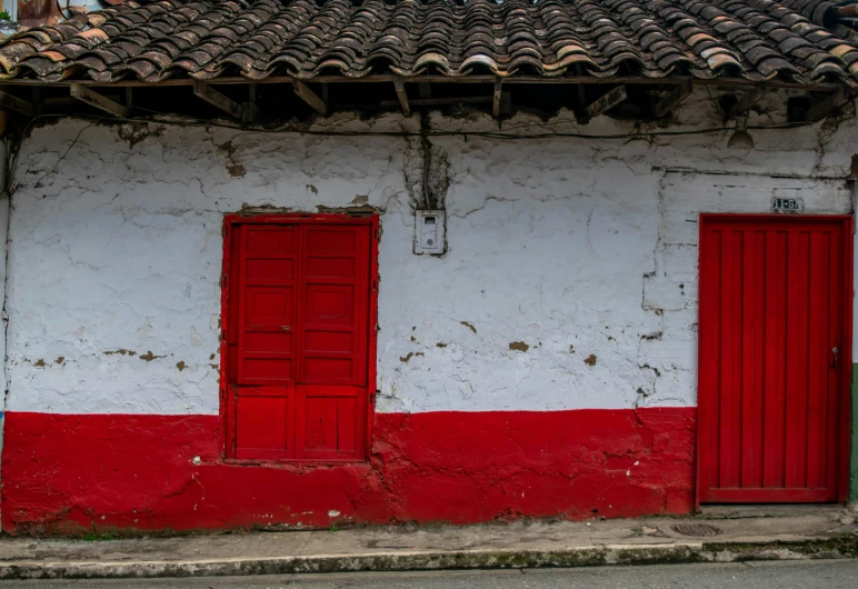 a red and white building with two doors