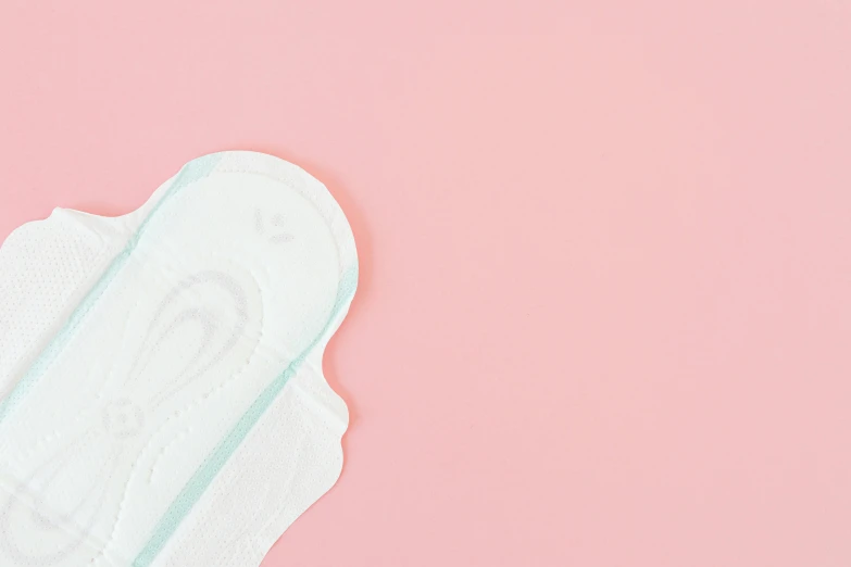 two white face pads on a pink background