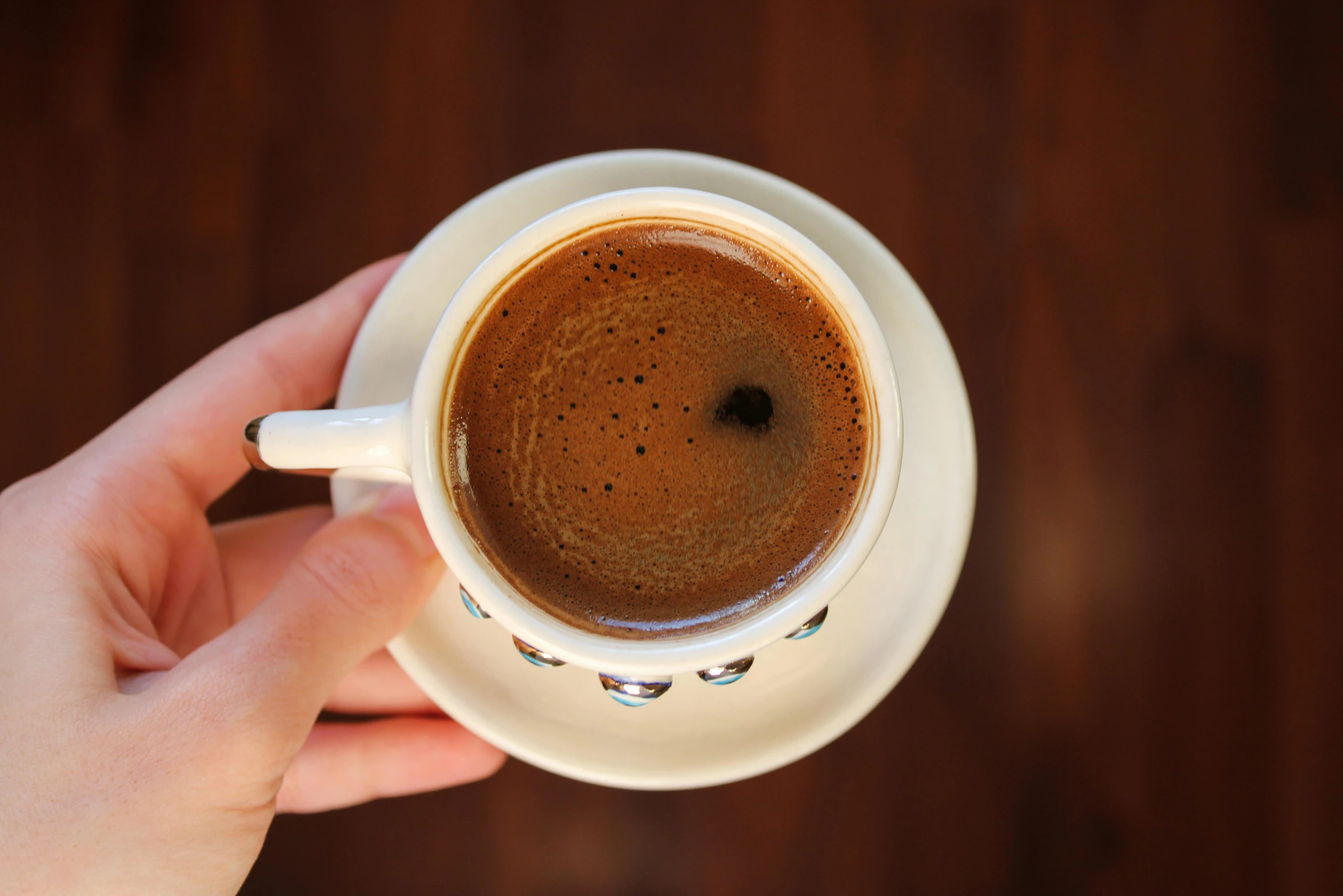 the top of a coffee cup with a brown substance in it