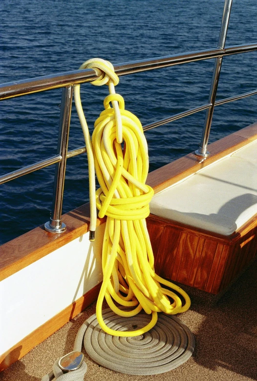 yellow rope with two spools on the edge of a boat deck