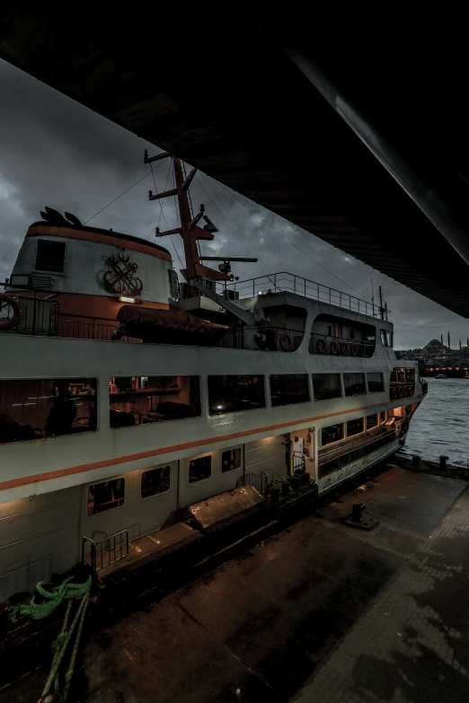 a big white train is docked in a harbor at night