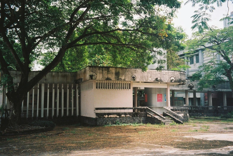 an old run down house with trees on the side