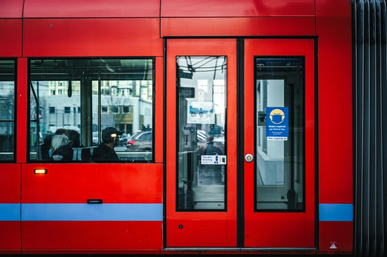 the people are entering the red subway train