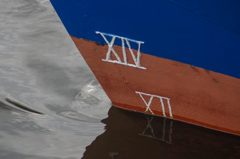 the bottom half of a big boat that is in some water