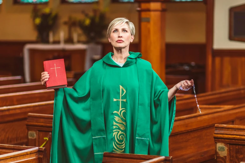 a woman standing in the pews in a church with a bible